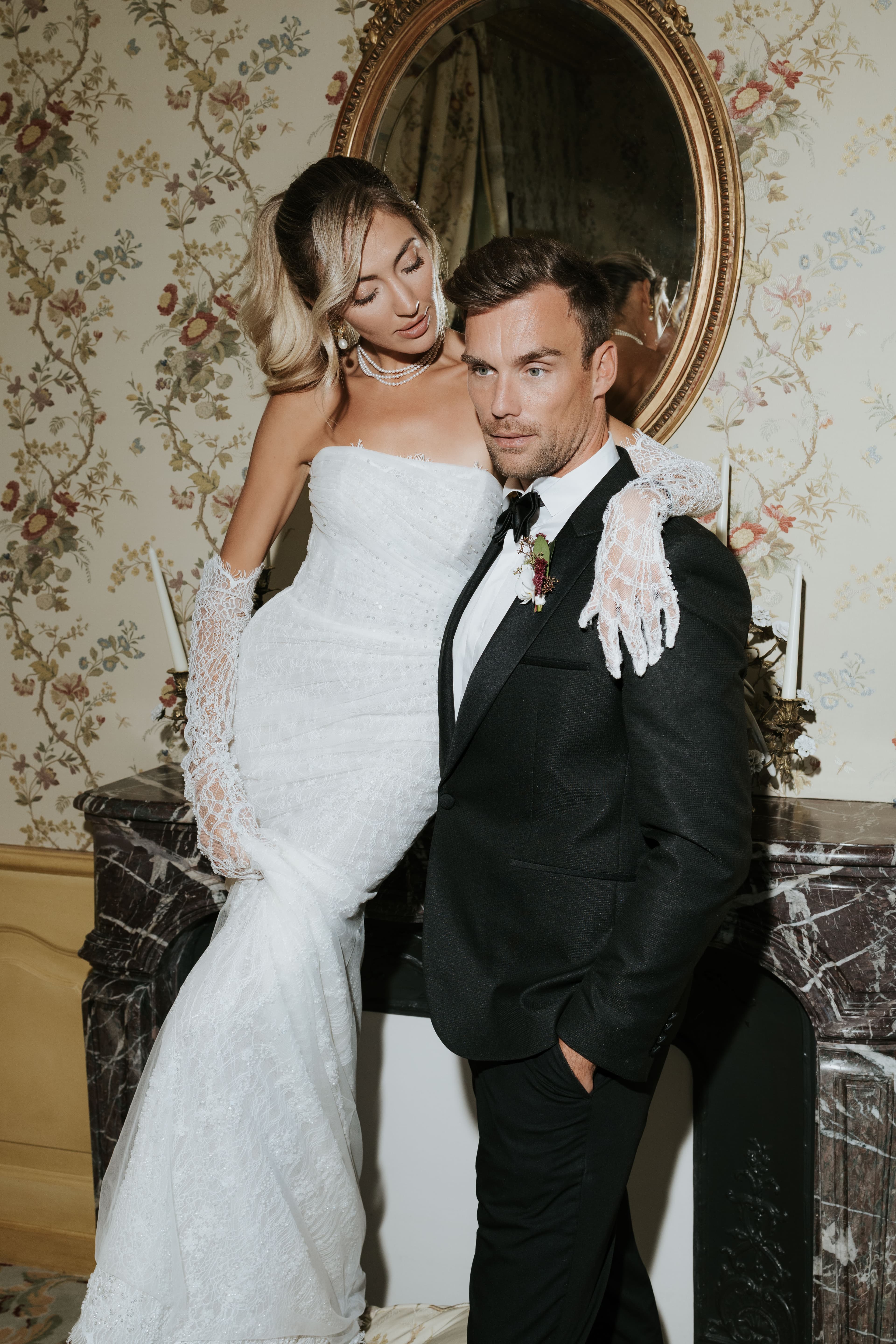 The couple at the marble fireplace