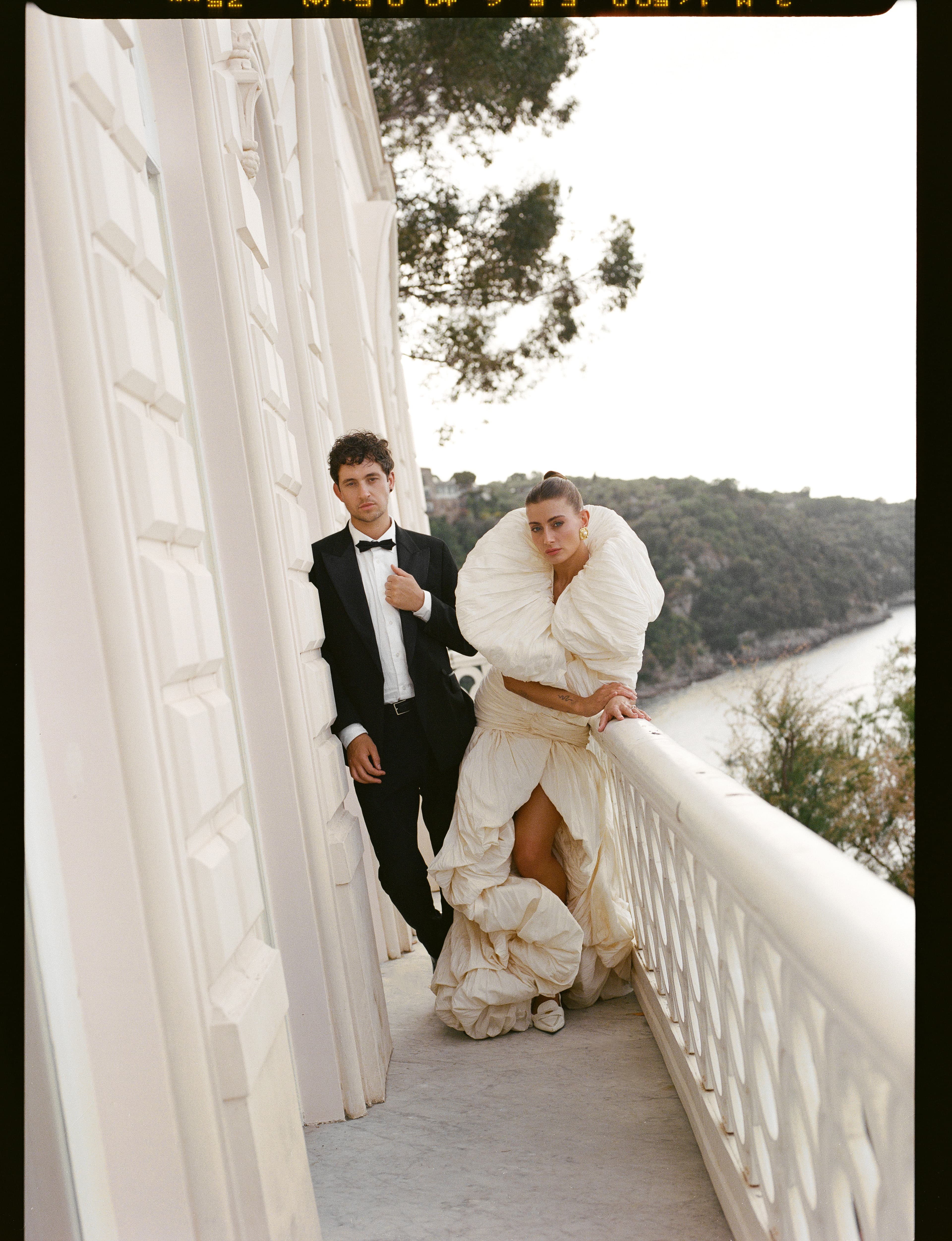 The couple on a balcony at dusk