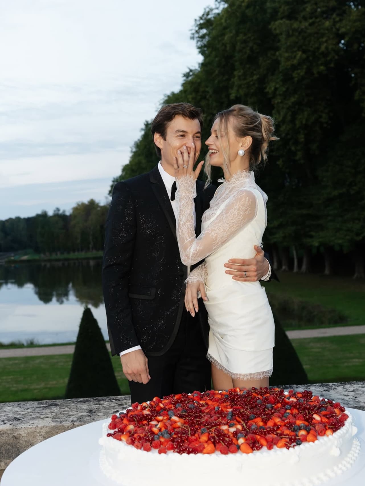 The couple by the cake at the lake