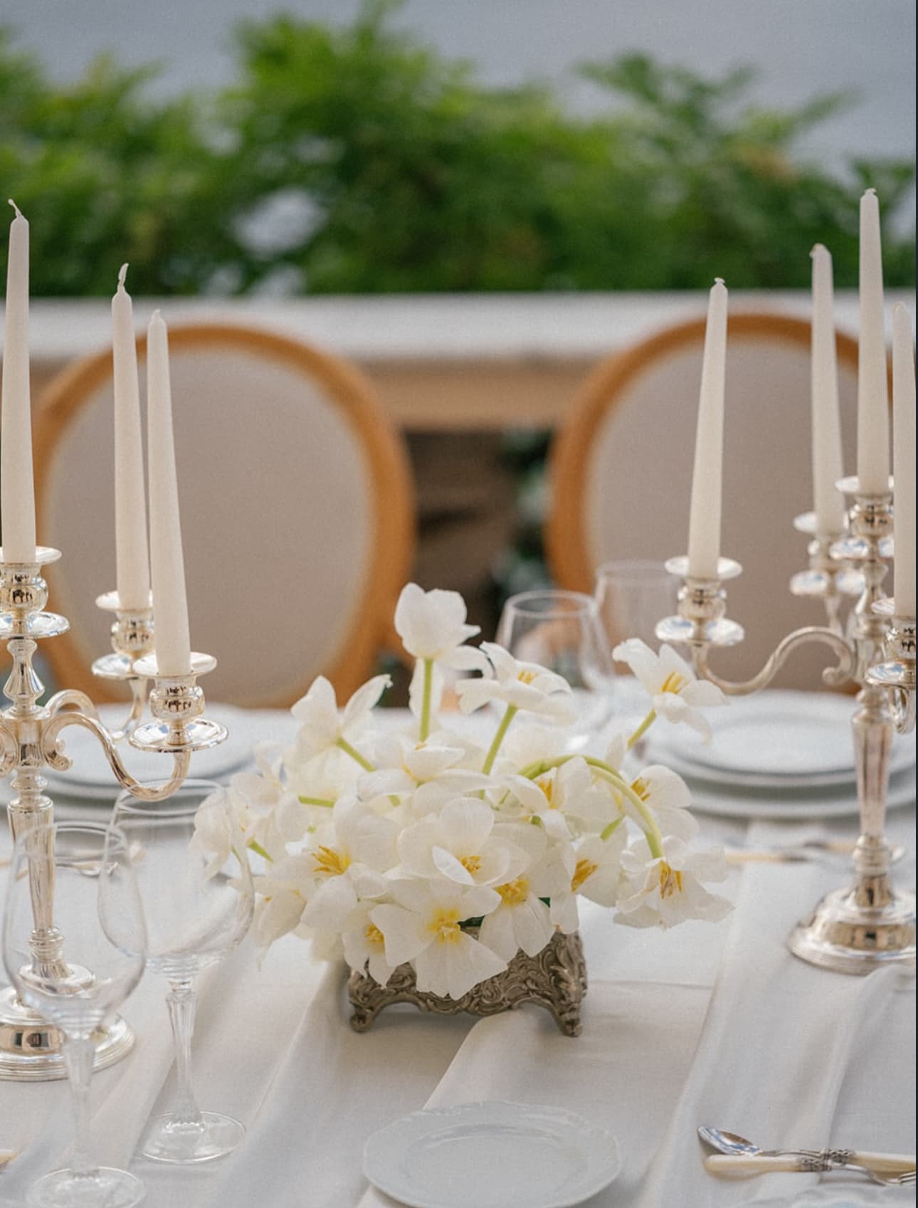 Silver candelabras with white tulips